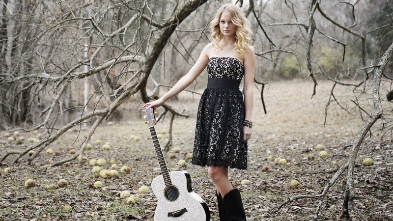 woman with guitar in woods