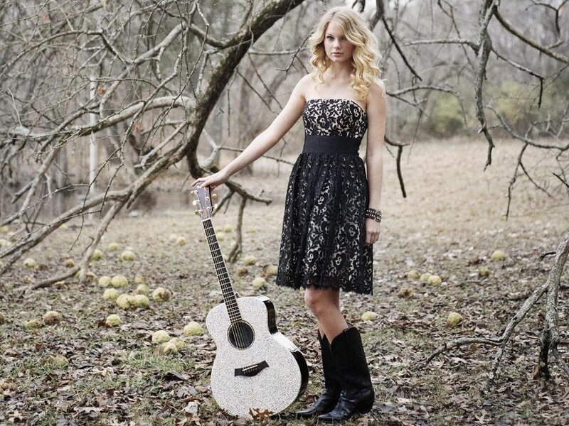 woman with guitar in woods