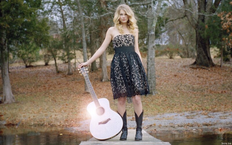 woman with guitar in woods