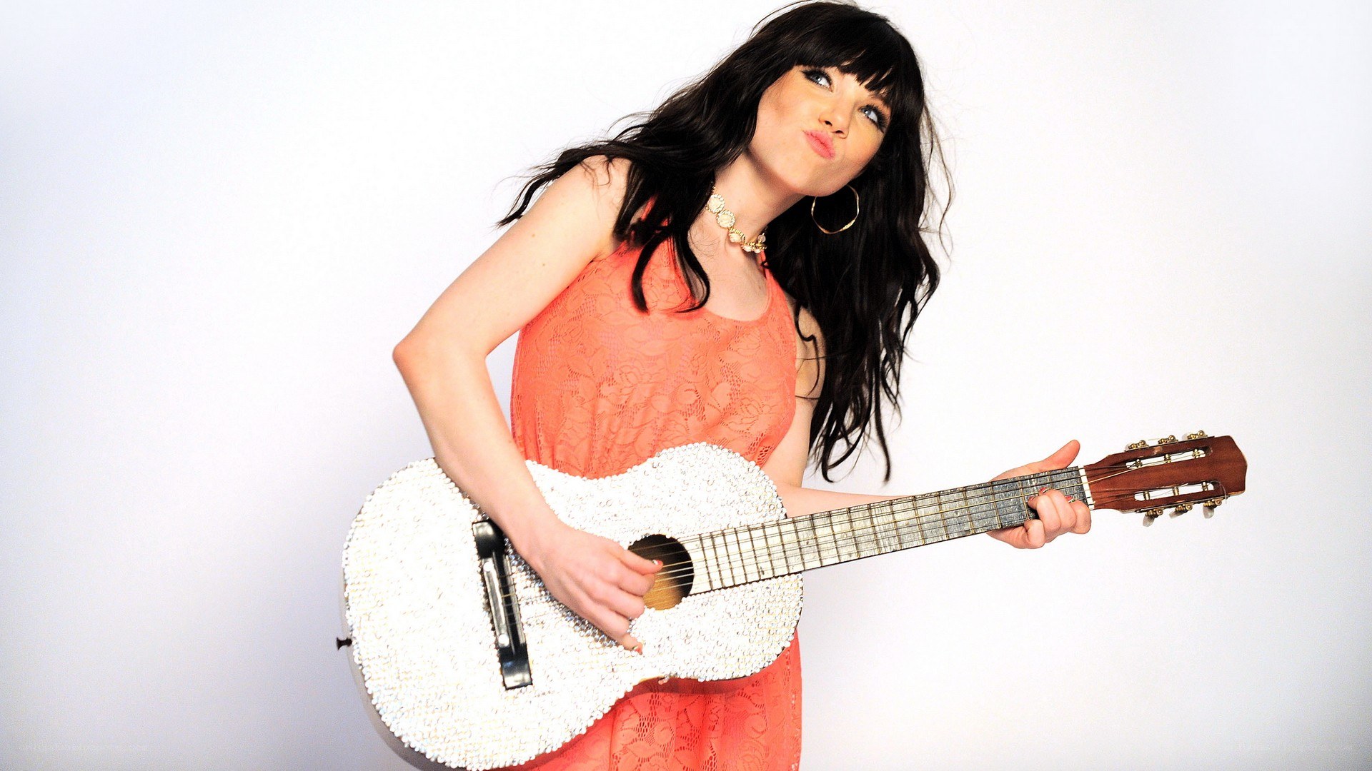 woman with guitar making a face