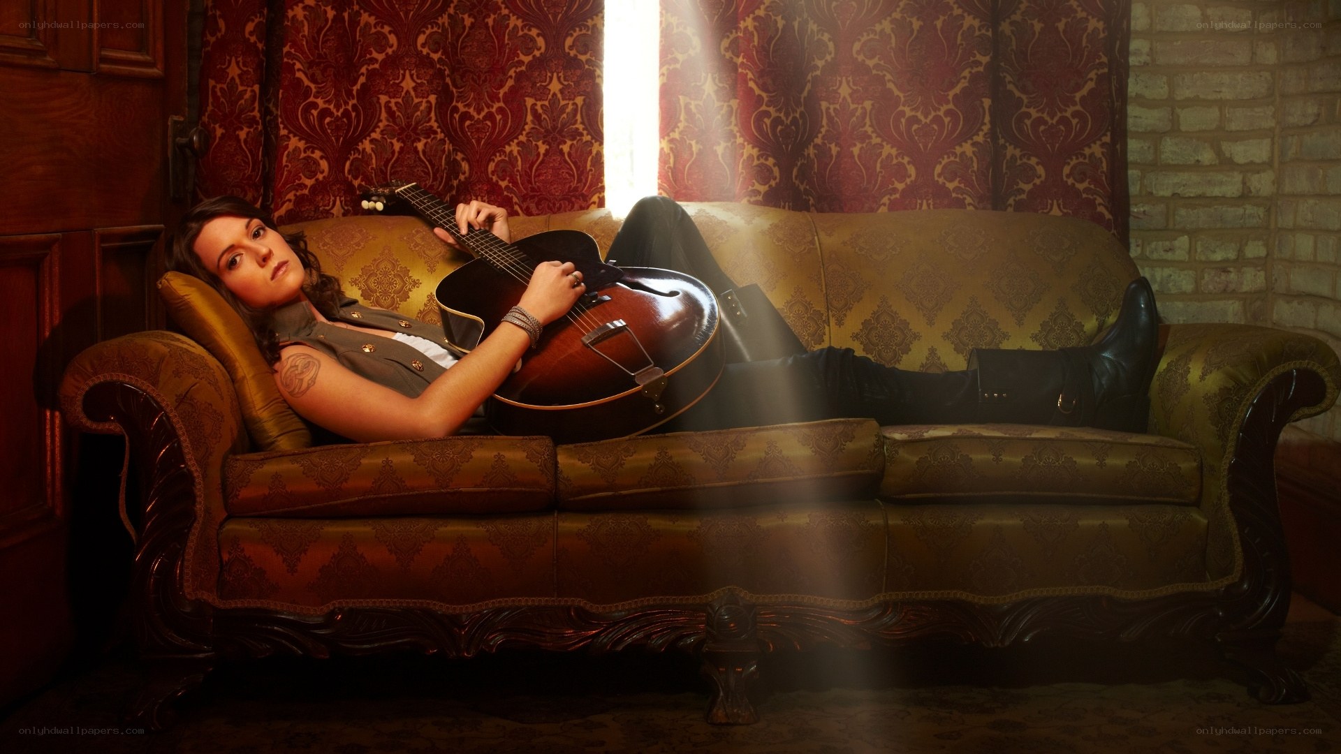 woman with guitar on couch