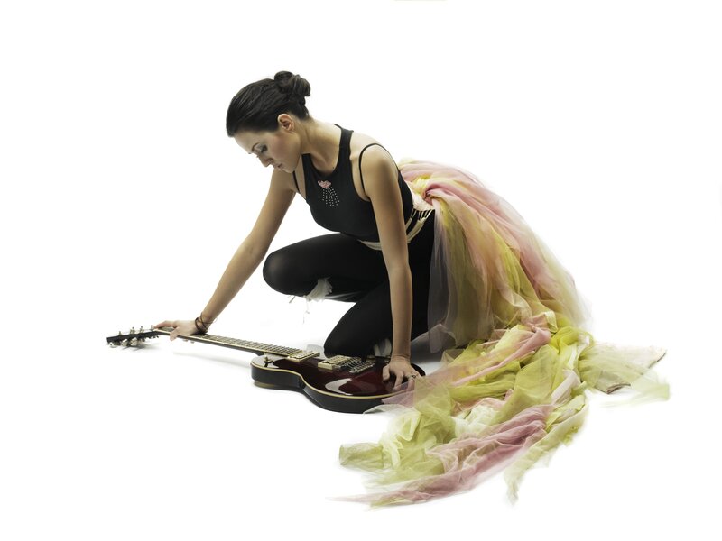 woman with guitar on floor