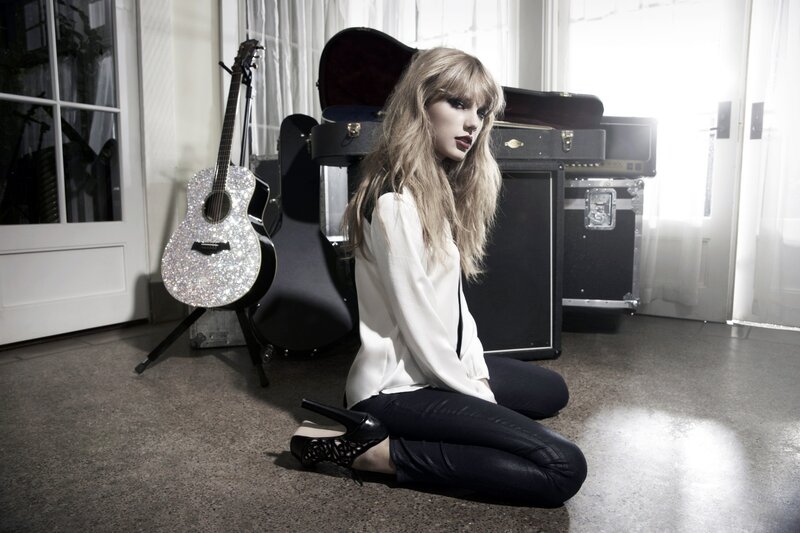 woman with guitar on floor