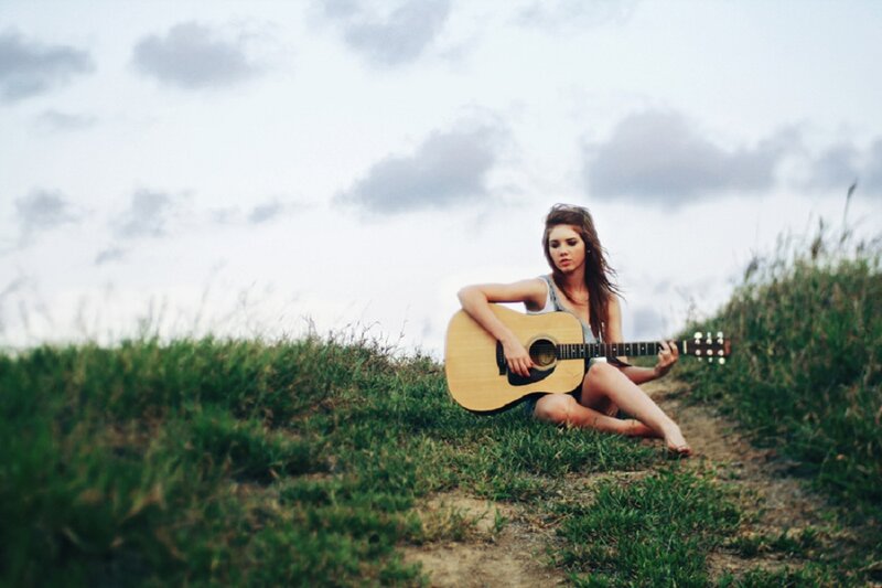 Woman with Guitar on Hill