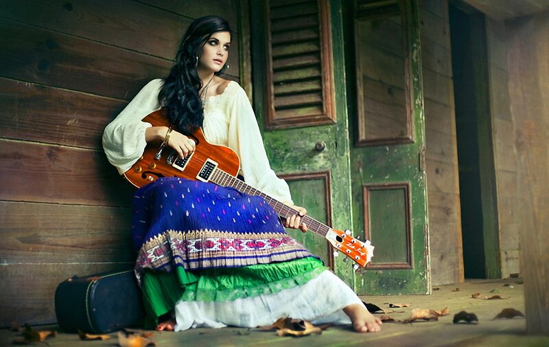 woman with guitar on porch