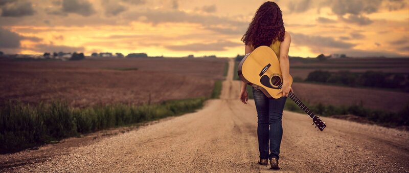Woman with Guitar on Road — Brown, Dramatic