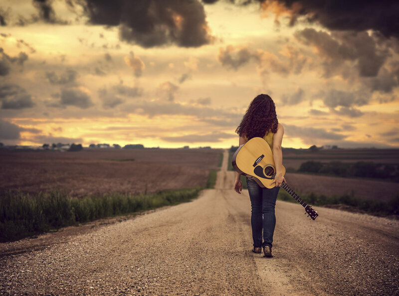 Woman with Guitar on Road — Brown