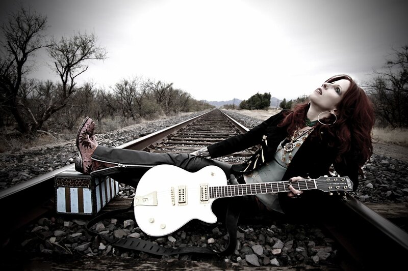 Woman with Guitar on Tracks