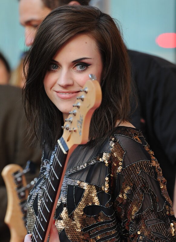 Woman with guitar smiling