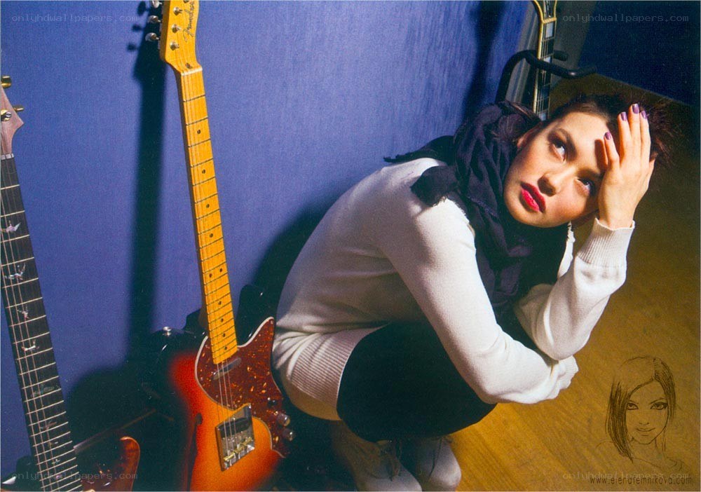 woman with guitars in studio