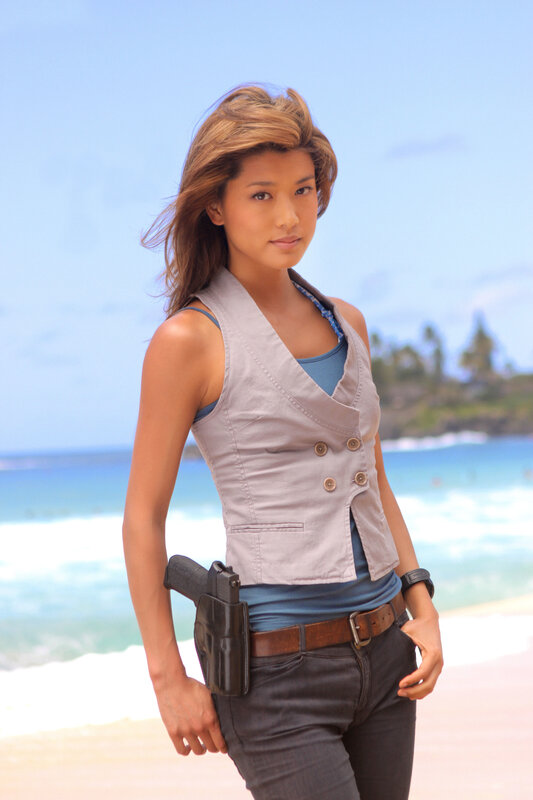 woman with gun on beach