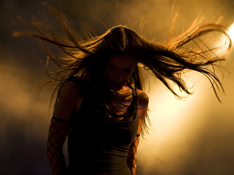 woman with hair flying in light