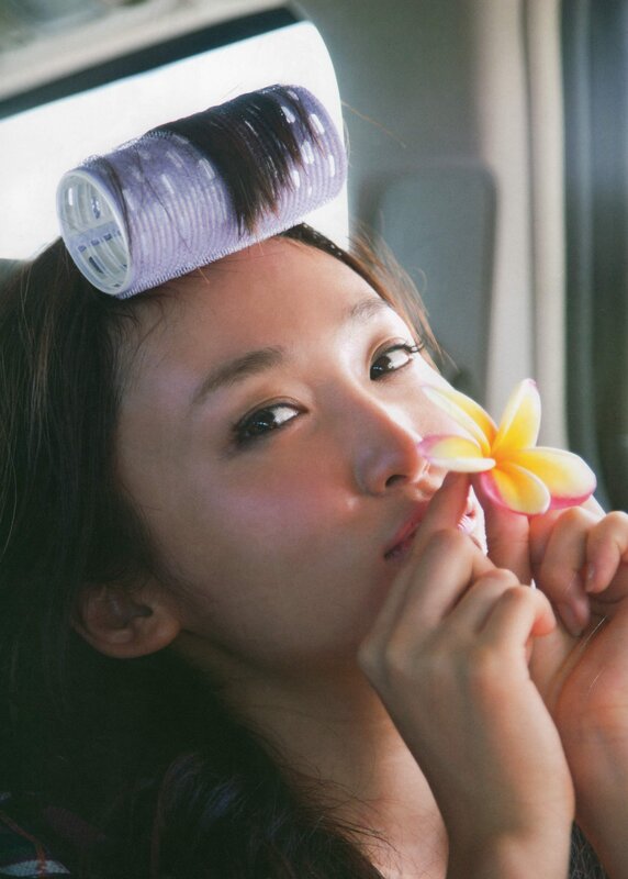 woman with hair roller and flower