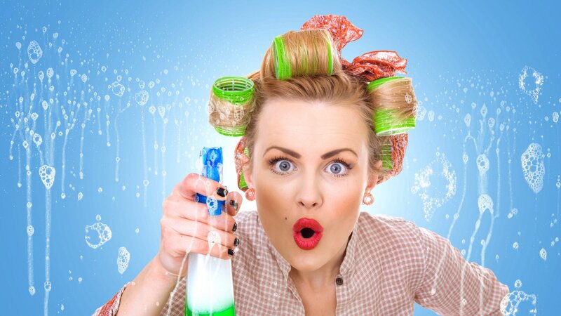 woman with hair rollers cleaning