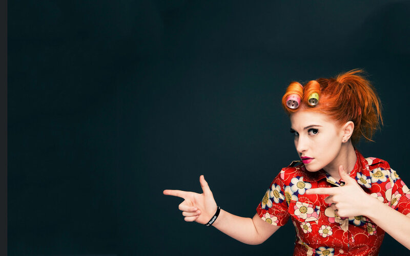 woman with hair rollers pointing