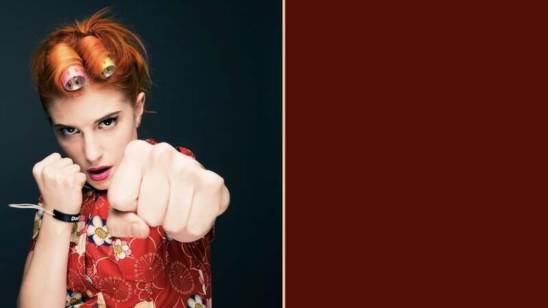 woman with hair rollers pointing
