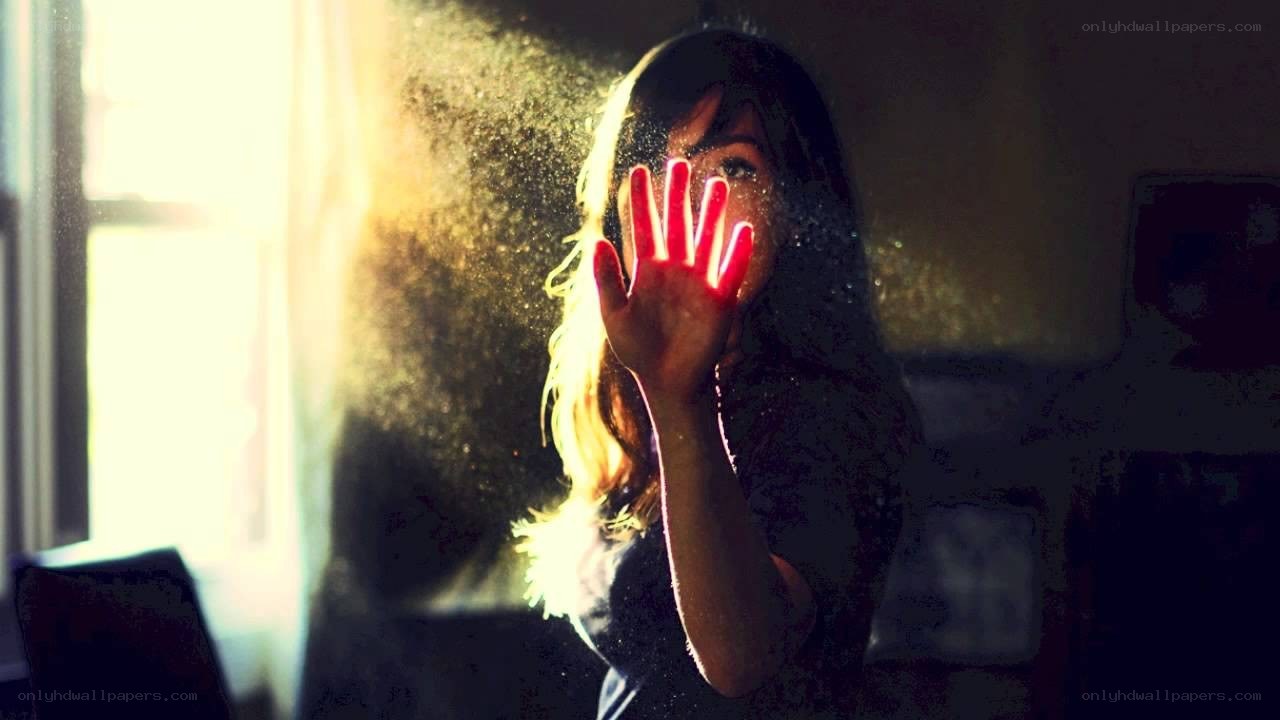 woman with hand in light