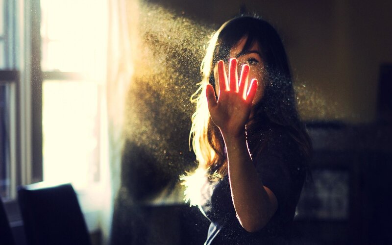 woman with hand in sunlight