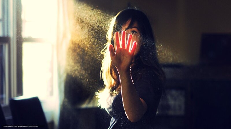 woman with hand in sunlight