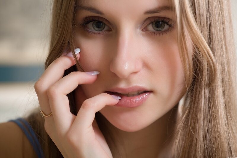 woman with hand near face