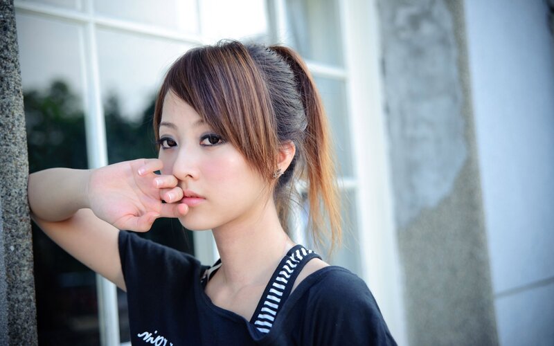 woman with hand near face
