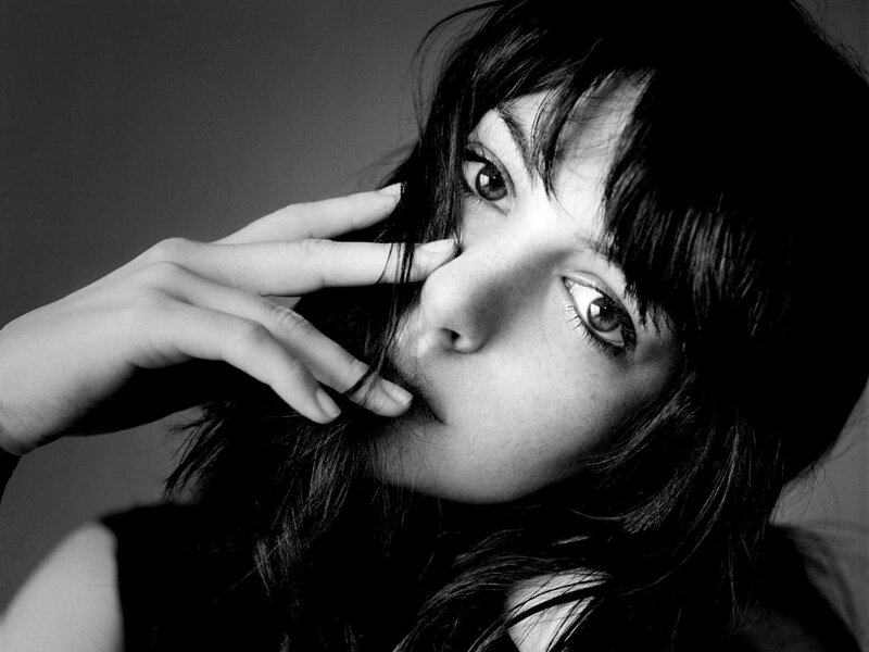 woman with hand near face