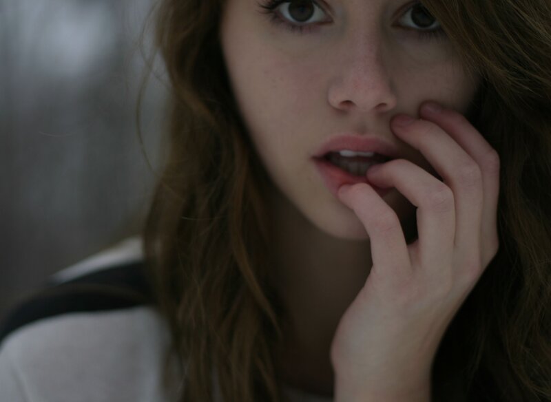 woman with hand near face