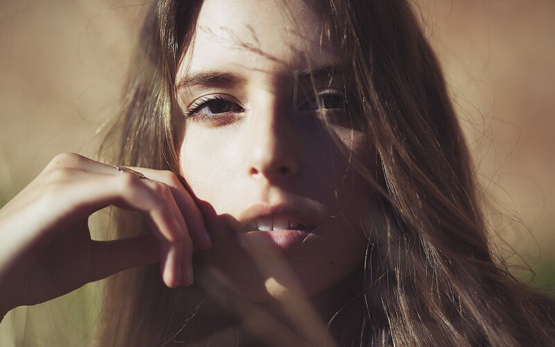 woman with hand near face