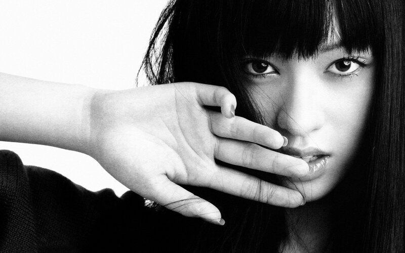 woman with hand near face