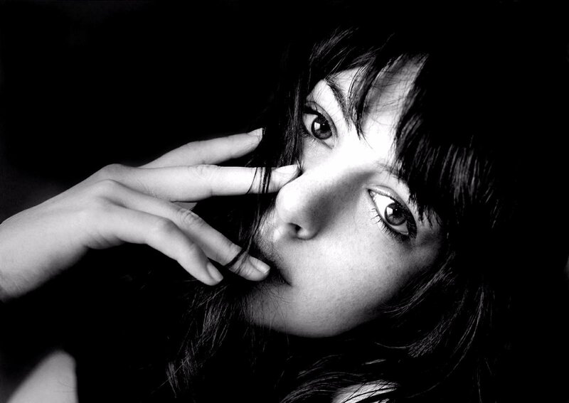 woman with hand near face