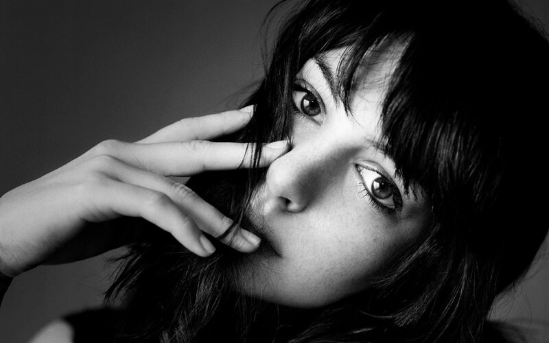woman with hand near face