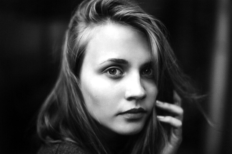 Woman with Hand Near Face — Black