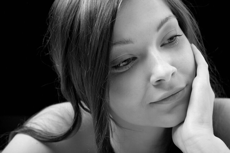 woman with hand on cheek
