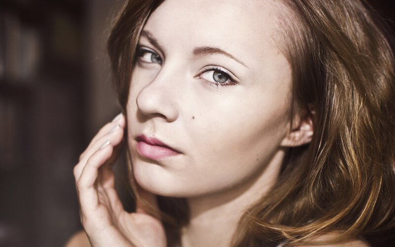 woman with hand on cheek