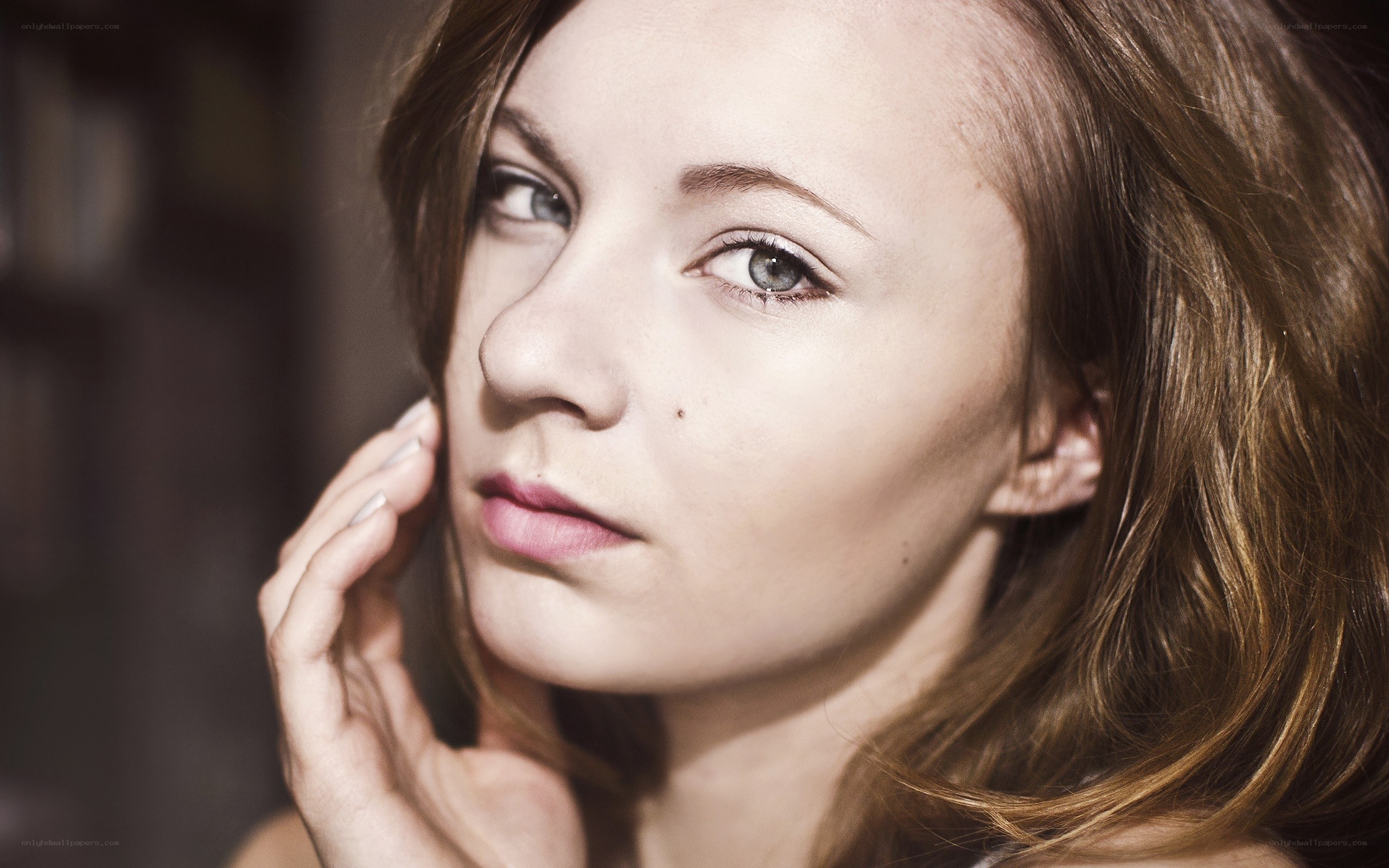 woman with hand on cheek