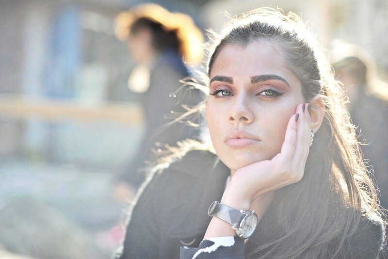 woman with hand on cheek