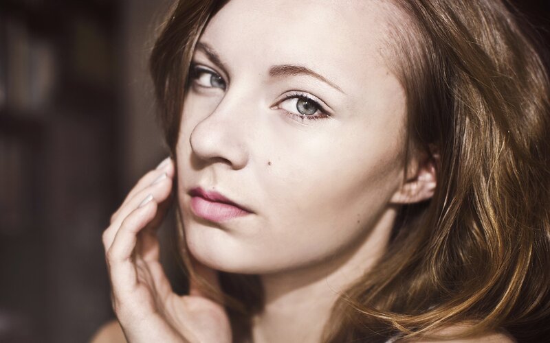 woman with hand on cheek