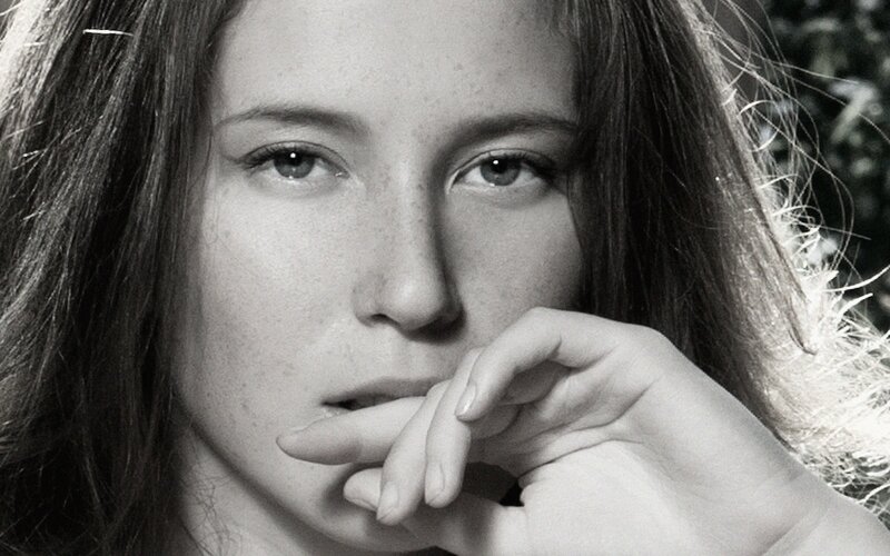 woman with hand on chin