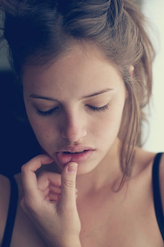 woman with hand on chin