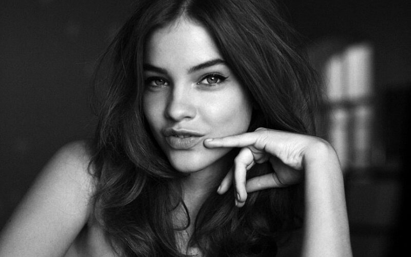 woman with hand on chin