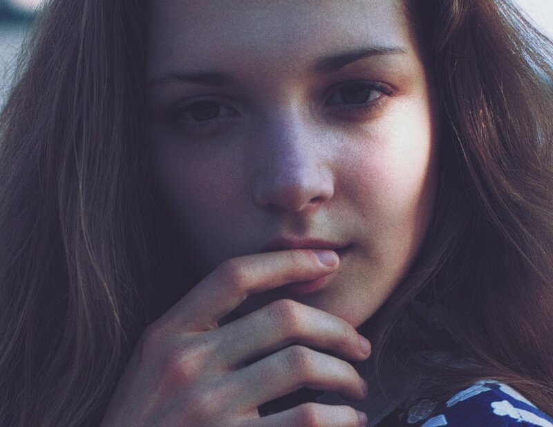 woman with hand on chin