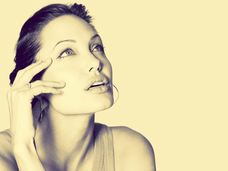 woman with hand on face