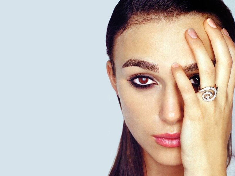 woman with hand on face