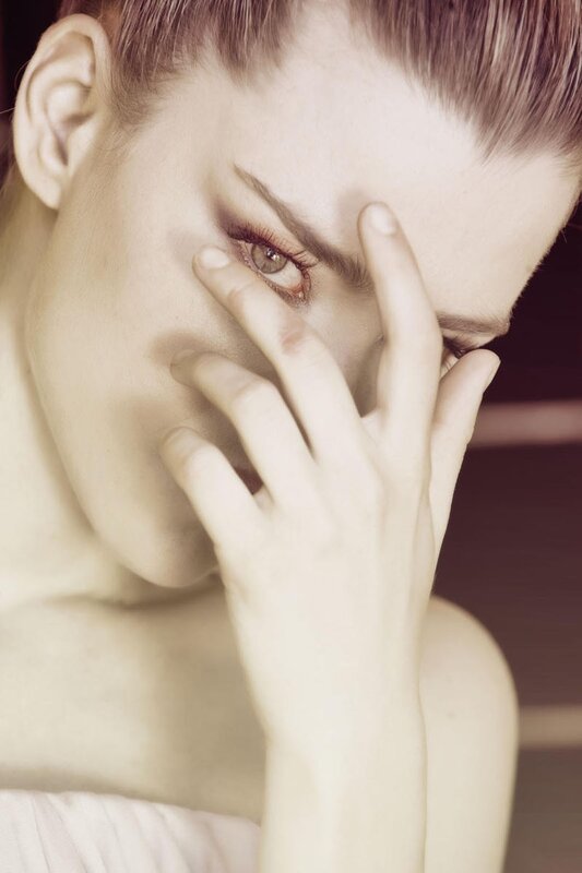 woman with hand on face