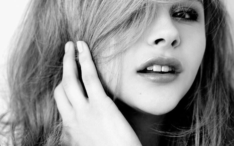 woman with hand on face