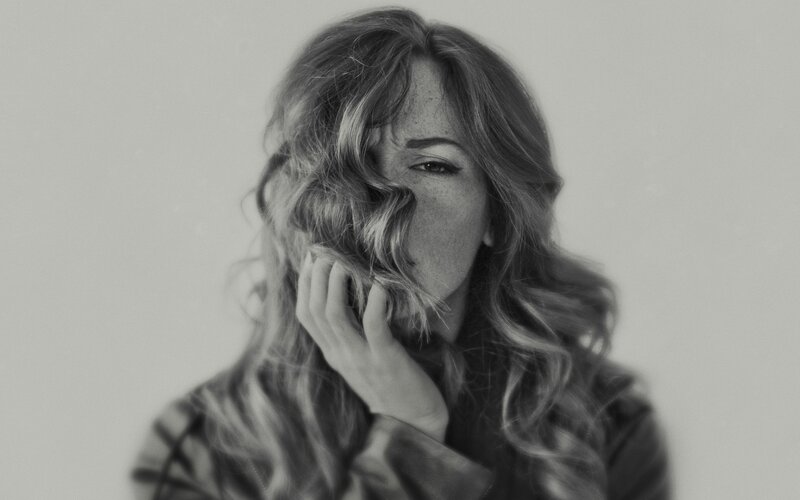 woman with hand on face