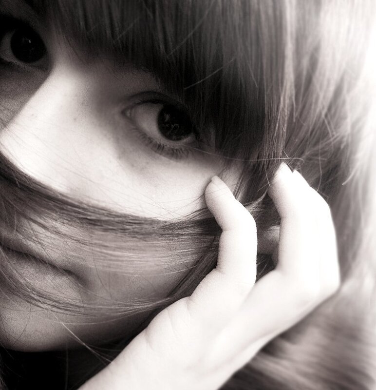 woman with hand on face