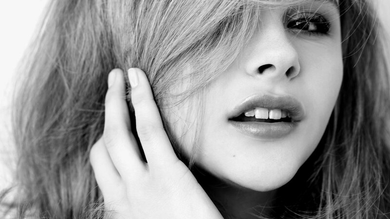 woman with hand on face