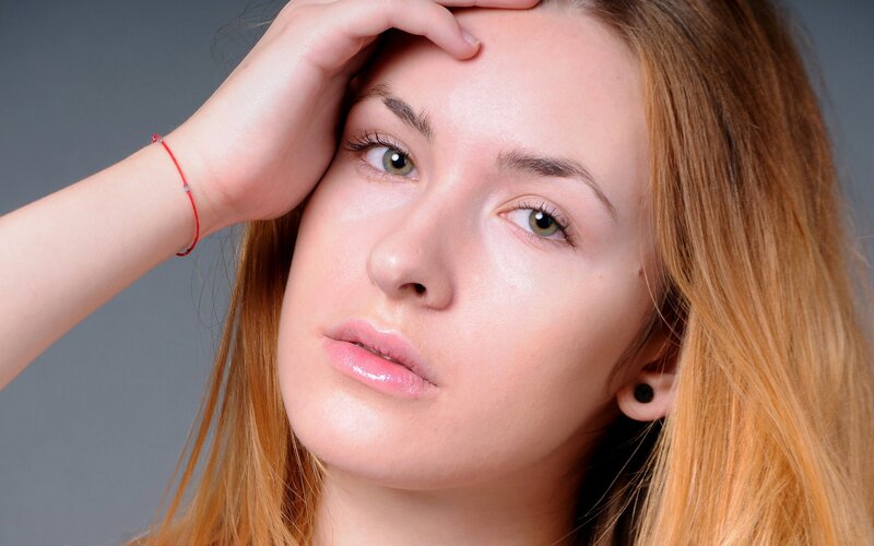 woman with hand on forehead