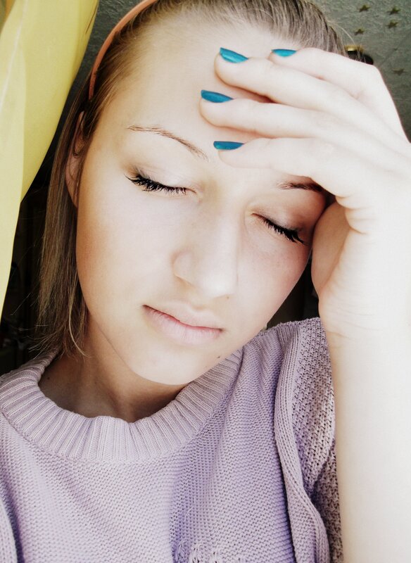 woman with hand on forehead